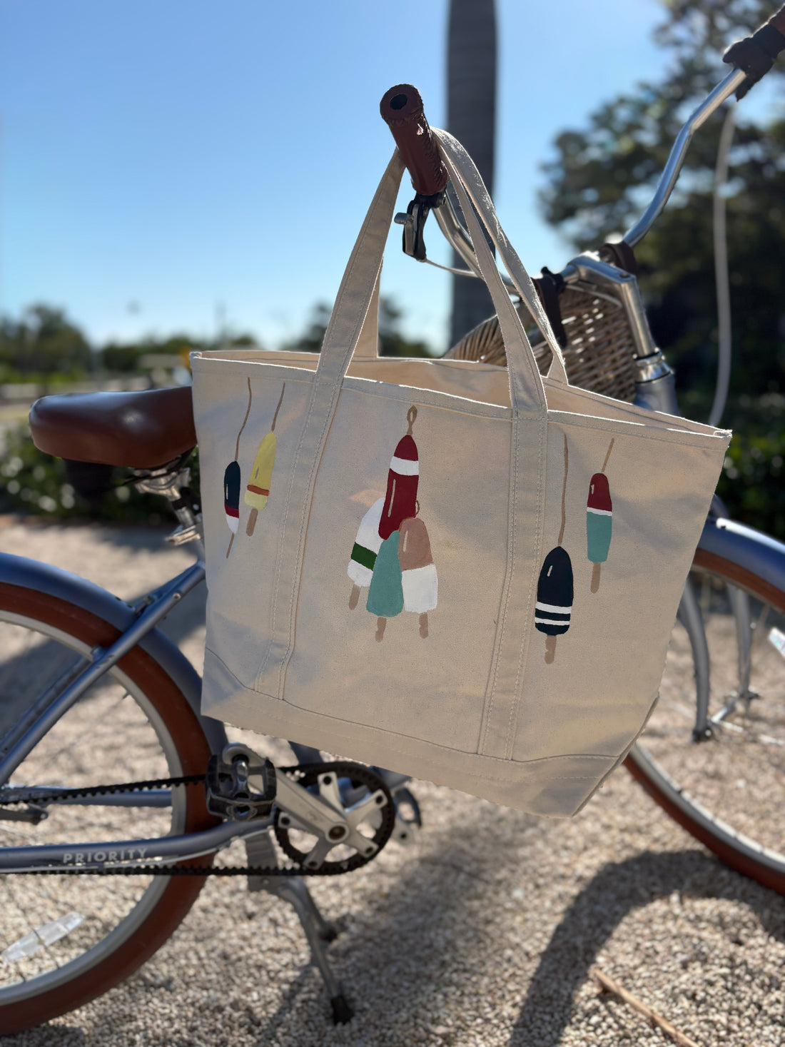 LBS Designs hand painted Nantucket signature status heritage canvas tote featuring buoys from harbor dockside
