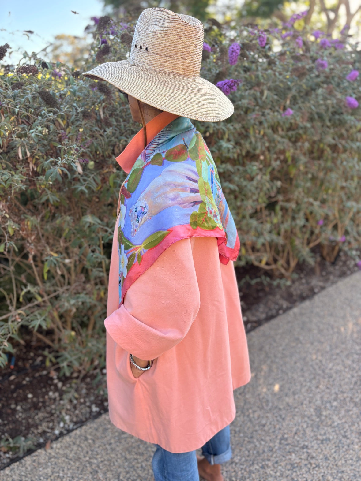 Naples silk scarf in Coral worn as a shawl